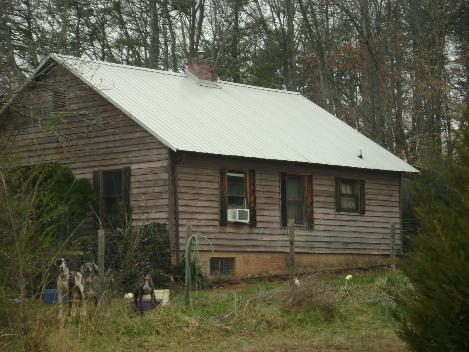 White metal roof on an old wood sided farmhouse, from a Metal Roof Installation job in Halstead